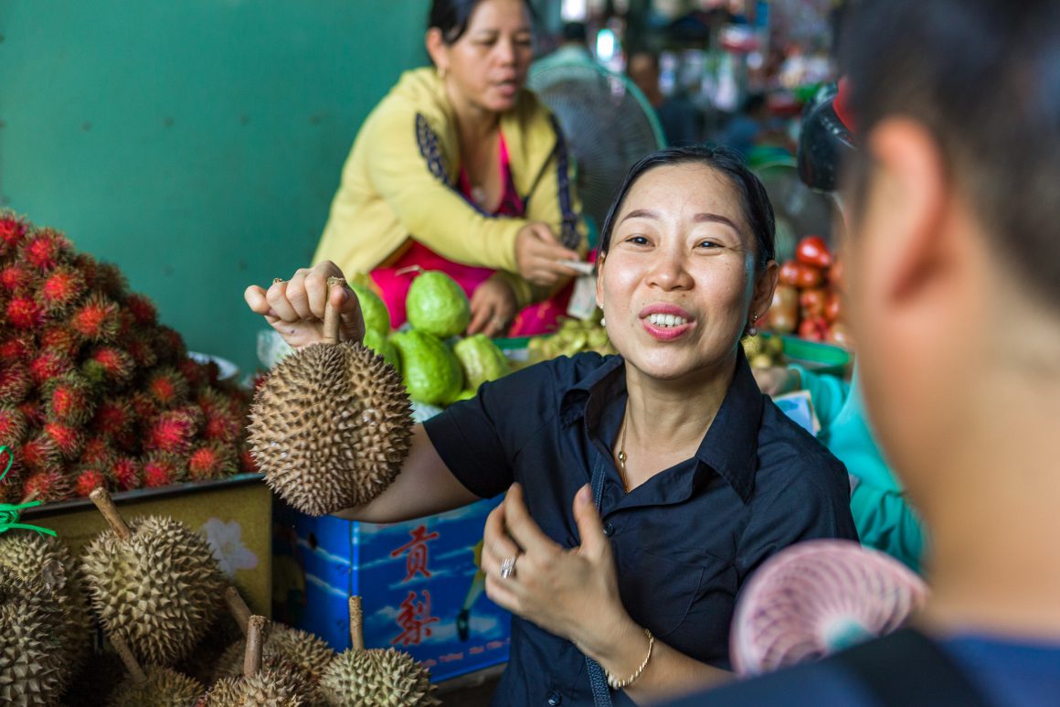 smiling lady with jackfruit in hand